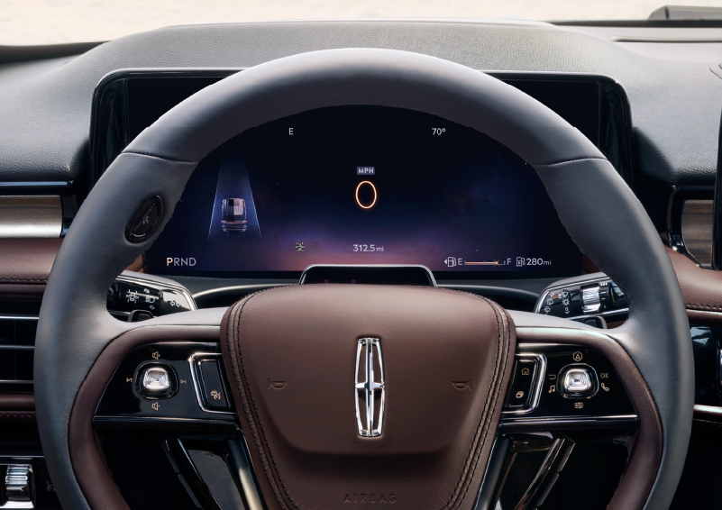 The steering wheel of 2025 Lincoln Aviator® SUV is shown with black and brown accents. | Parks Lincoln of Wesley Chapel in Wesley Chapel FL