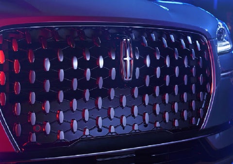 The grille of a 2025 Lincoln Corsair® SUV reflects neon light at night. | Parks Lincoln of Wesley Chapel in Wesley Chapel FL