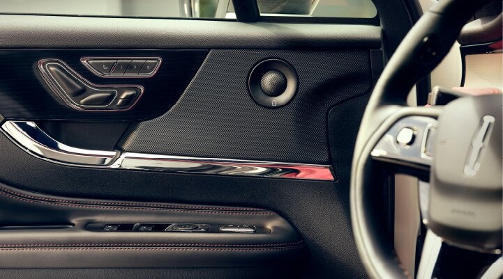 A Revel® audio speaker is shown in the driver's side door of a 2025 Lincoln Corsair® SUV. | Parks Lincoln of Wesley Chapel in Wesley Chapel FL