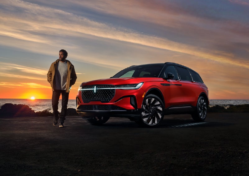 A person is shown next to a 2025 Lincoln Nautilus® SUV as the Lincoln Embrace sequence takes place. | Parks Lincoln of Wesley Chapel in Wesley Chapel FL
