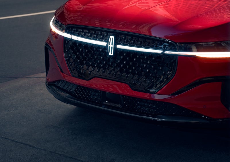 The available front LED light bar and center Lincoln Star logo glow at dusk. | Parks Lincoln of Wesley Chapel in Wesley Chapel FL