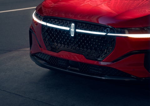 The available front LED light bar and center Lincoln Star logo glow at dusk. | Parks Lincoln of Wesley Chapel in Wesley Chapel FL