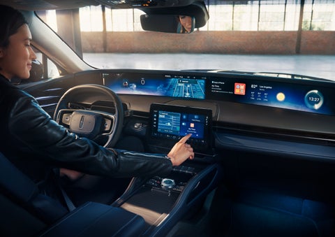 The driver of a 2025 Lincoln Nautilus® SUV interacts with the center touchscreen. | Parks Lincoln of Wesley Chapel in Wesley Chapel FL