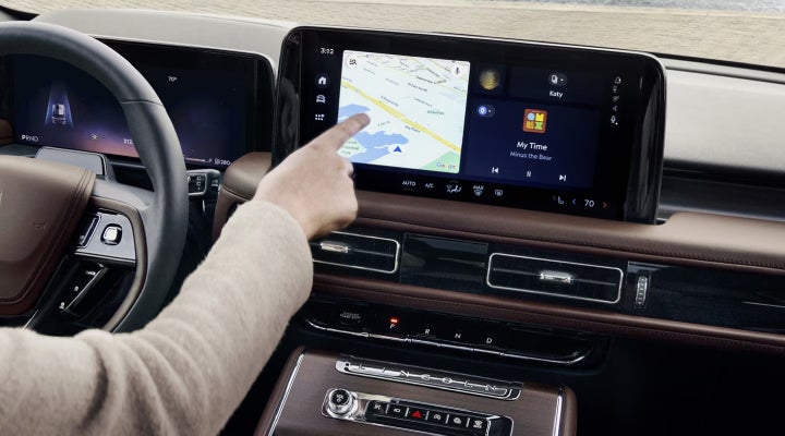 A person is tapping the center display touchscreen of a 2026 Lincoln Aviator® SUV. | Parks Lincoln of Wesley Chapel in Wesley Chapel FL
