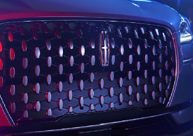 The grille of a 2025 Lincoln Corsair&reg; SUV reflects neon light at night. | Parks Lincoln of Wesley Chapel in Wesley Chapel FL
