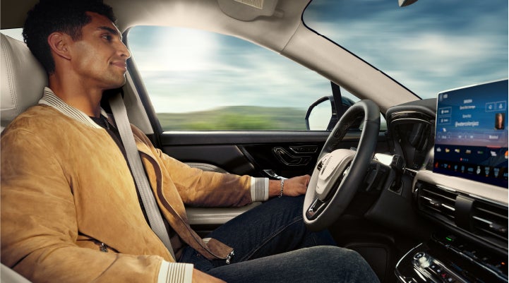 A person is shown using Lincoln BlueCruise hands-free highway driving technology on a divided highway in a hands-free Blue Zone. | Parks Lincoln of Wesley Chapel in Wesley Chapel FL
