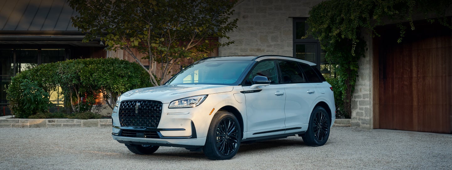 A 2026 Lincoln Corsair® SUV is parked in front off a luxury home. | Parks Lincoln of Wesley Chapel in Wesley Chapel FL