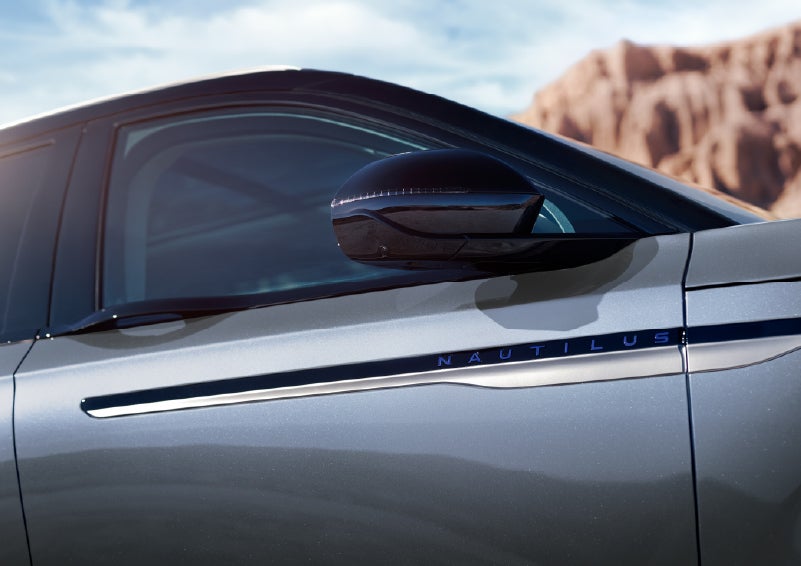 Blue lettering on the side of the vehicle that reads Nautilus indicates the available Hybrid Powertrain. | Parks Lincoln of Wesley Chapel in Wesley Chapel FL