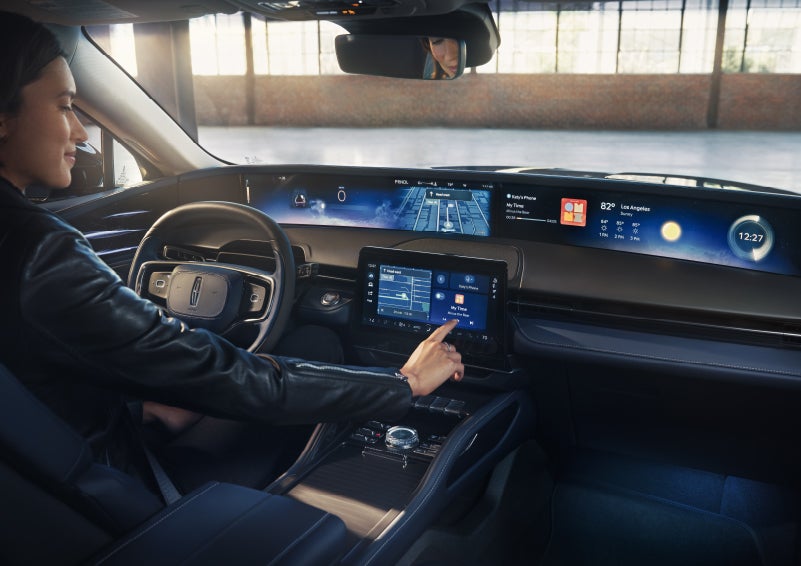The driver of a 2026 Lincoln Nautilus® SUV interacts with the center touchscreen. | Parks Lincoln of Wesley Chapel in Wesley Chapel FL