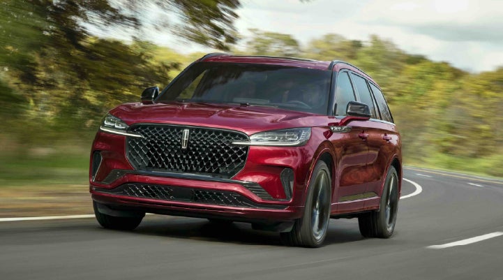 A 2027 Lincoln Aviator® SUV is being driven on a country road | Parks Lincoln of Wesley Chapel in Wesley Chapel FL