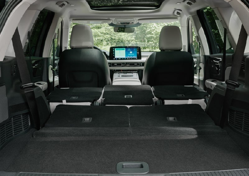A rear to front view of the interior of a 2027 Lincoln Aviator® Black Label™ SUV shows the third and second rows folded flat | Parks Lincoln of Wesley Chapel in Wesley Chapel FL
