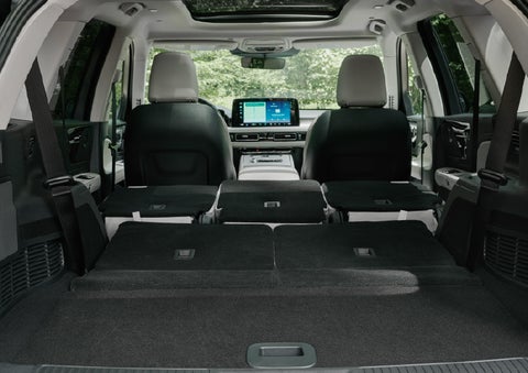 A rear to front view of the interior of a 2027 Lincoln Aviator® Black Label™ SUV shows the third and second rows folded flat | Parks Lincoln of Wesley Chapel in Wesley Chapel FL