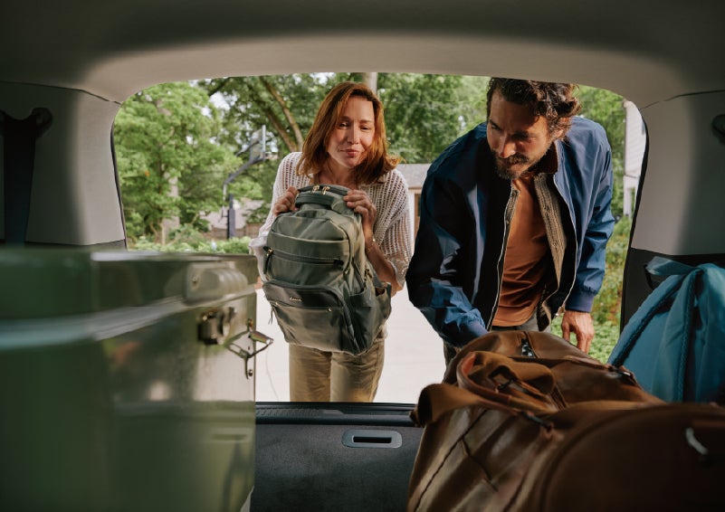 A couple loads luggage into the rear of a 2027 Lincoln Aviator® Black Label™ SUV..e 202 | Parks Lincoln of Wesley Chapel in Wesley Chapel FL