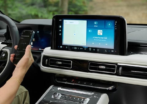 A person pairs thier phone with the center touchscreen of a 2027 Lincoln Aviator® Black Label™ SUV | Parks Lincoln of Wesley Chapel in Wesley Chapel FL